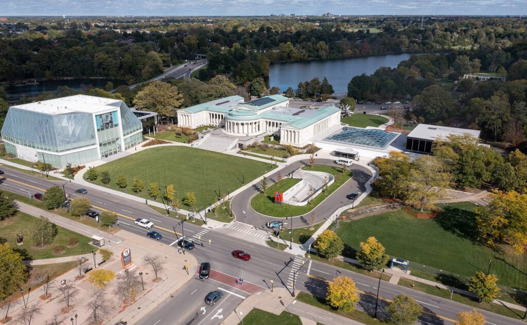 Aerial view of the Buffalo AKG Art Museum campus in fall, with the glass Gundlach Building, the 1905 classical building and Hoyt Lake, the heart of Buffalo NY museums and art