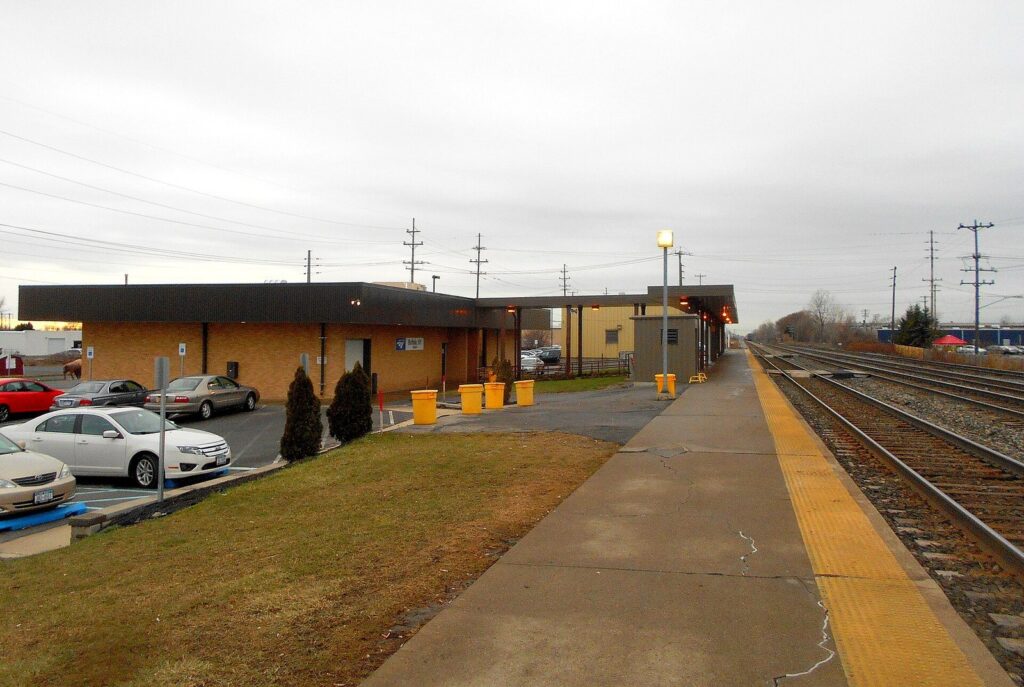 The low brick station building and long platform at the Buffalo-Depew Amtrak station