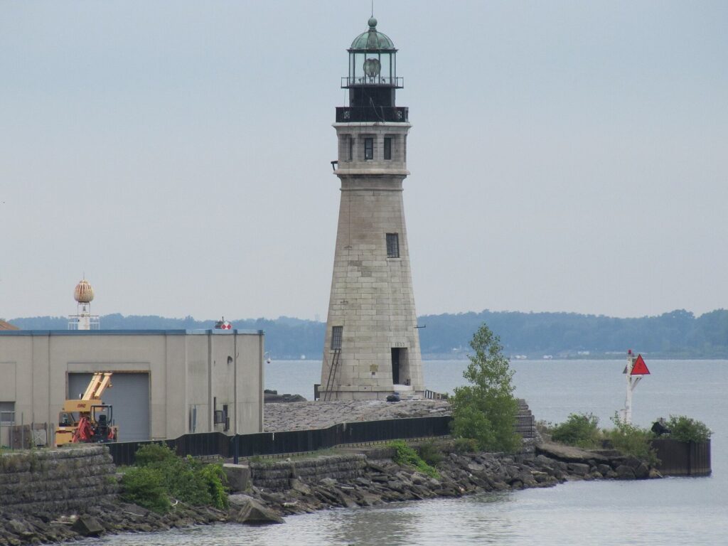 The stone Buffalo Lighthouse at the mouth of the Buffalo River, with Lake Erie behind