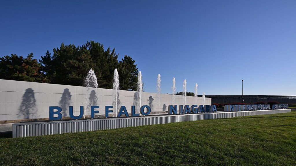 The Buffalo Niagara International Airport sign with fountains in front of it on a sunny day