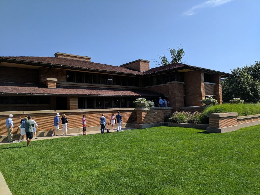 Frank Lloyd Wright's Darwin D. Martin House, a landmark of Buffalo NY architecture and history, with a tour group on the front walk