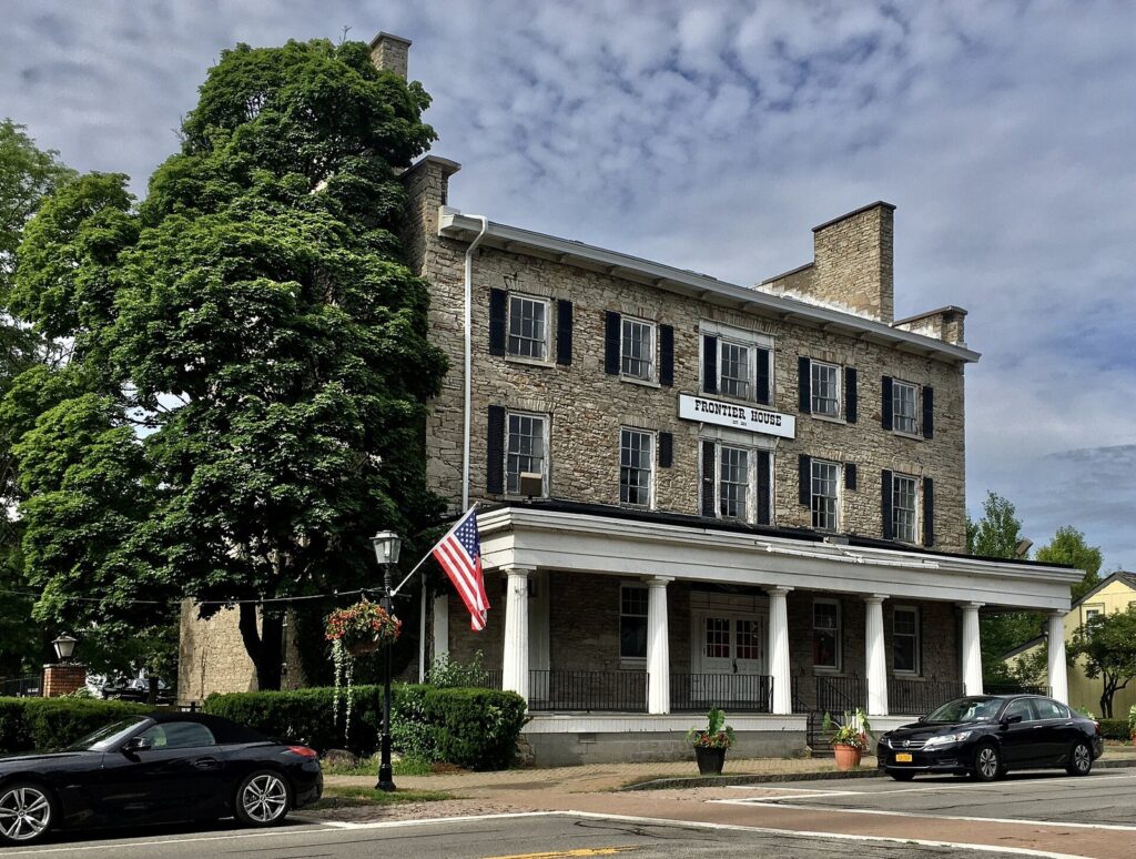 The stone Frontier House with its white columned porch on Center Street in Lewiston, New York