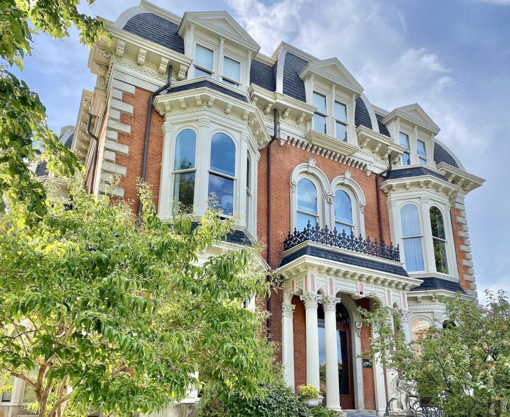 The red-brick Mansion on Delaware Avenue in Buffalo, with its mansard roof and white window surrounds